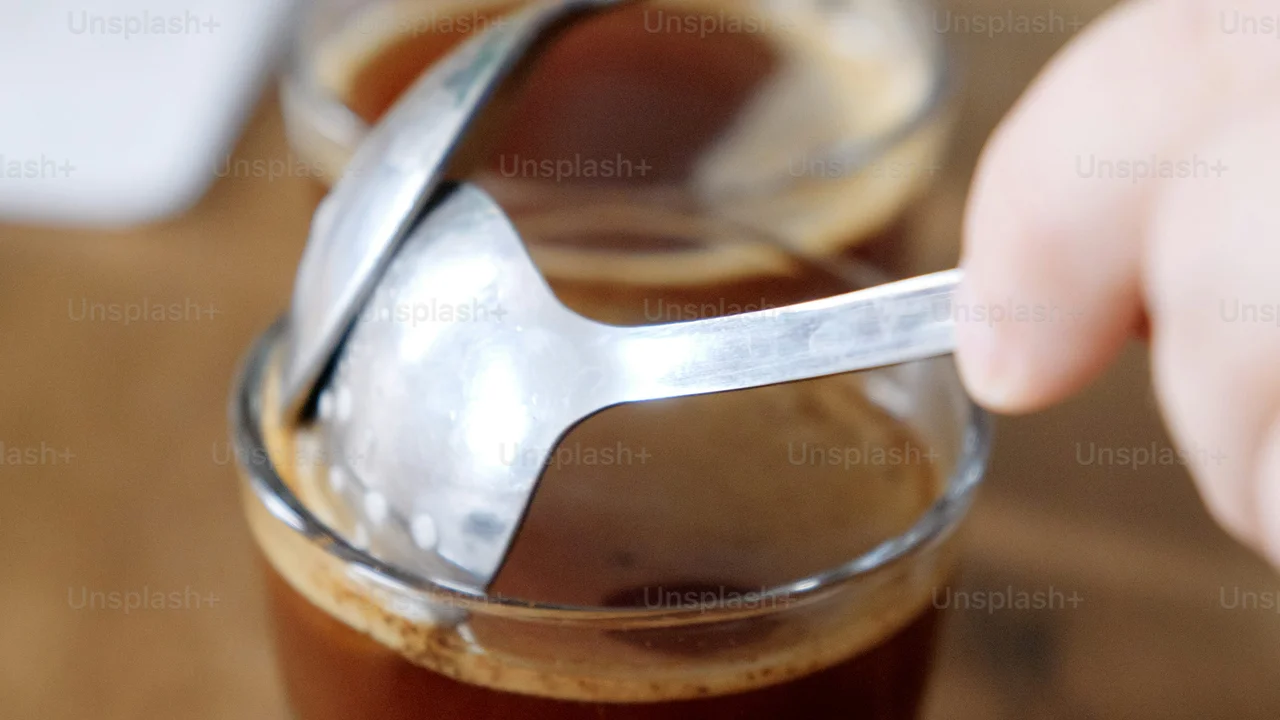 blue bowl of black bean beef tortilla soup on a board with cilantro and shredded cheese in background